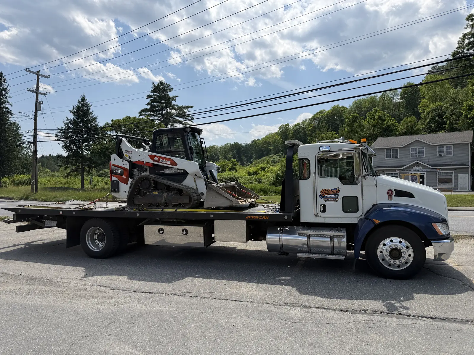 Wilson’s Towing transporting construction equipment