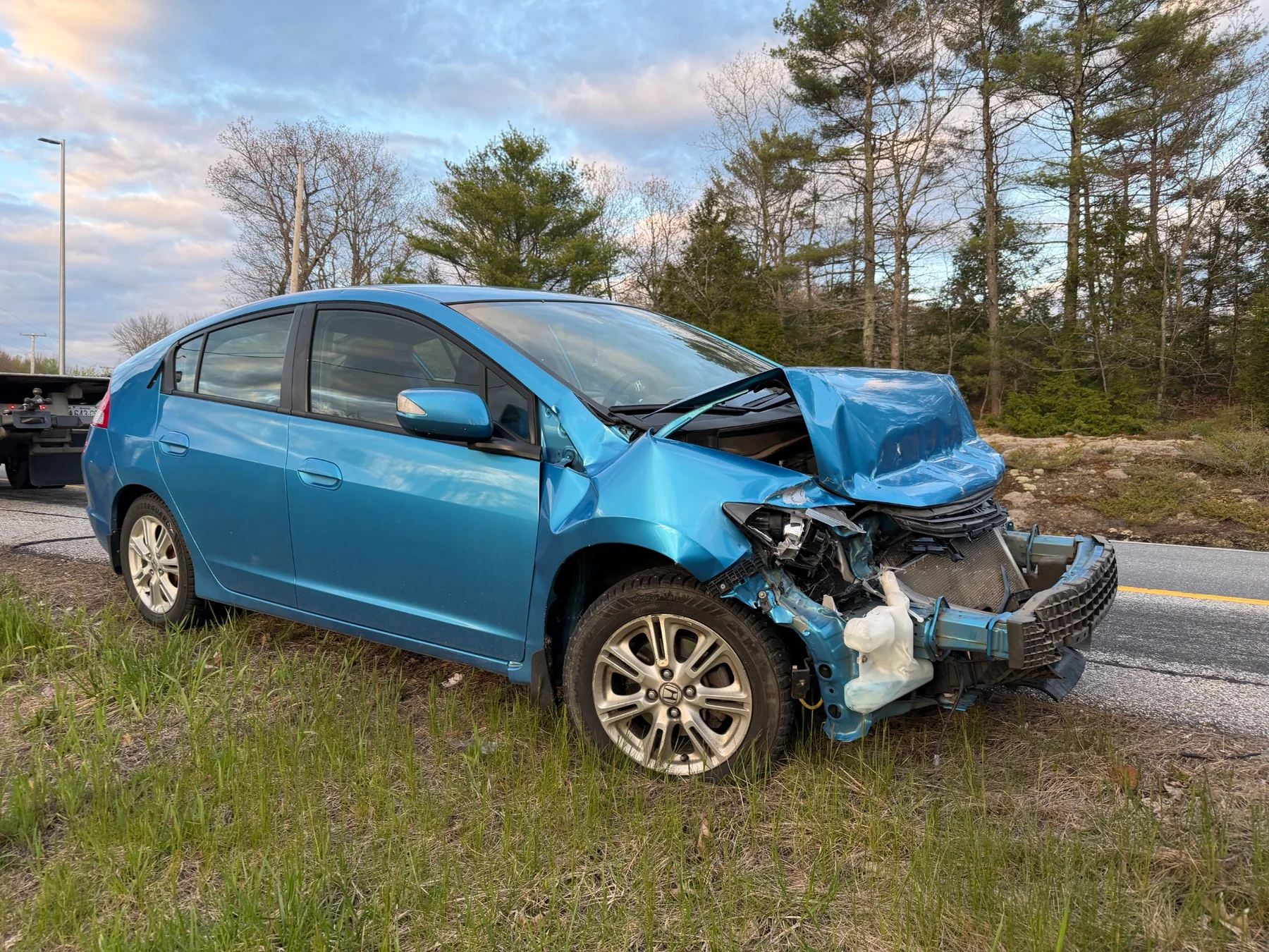 Collision-damaged car awaiting professional accident towing in Central Maine